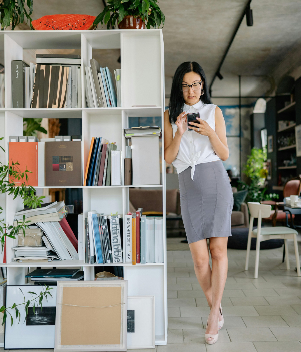 Business owner checking her phone in a modern office